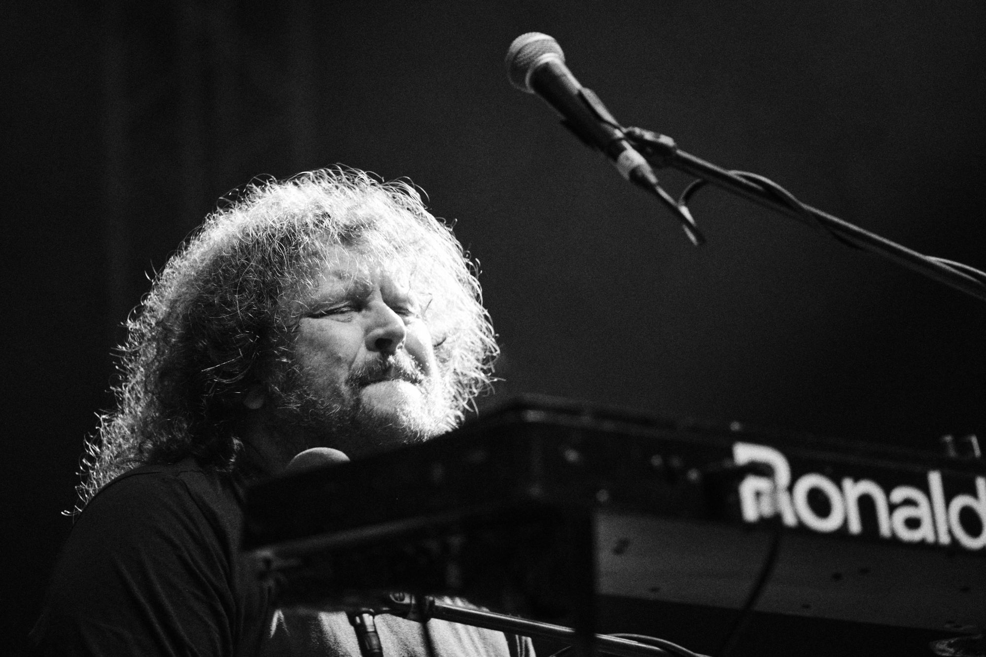 Black and white photo of Roman Holy from J.A.R. performing at Rock for Churchill